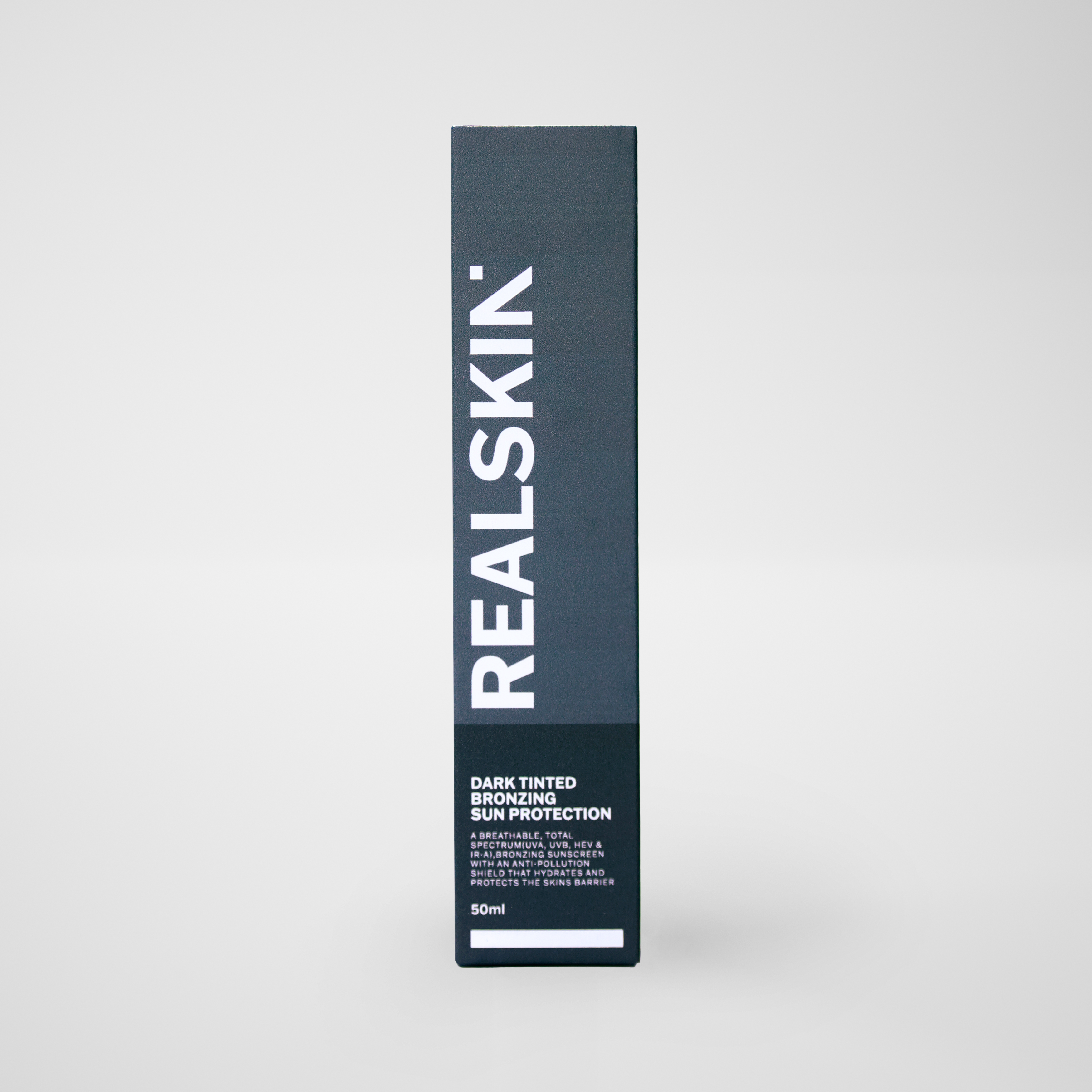 Realskin Sun Protection Dark Tinted Bronzing in a two-tone dark grey rectangle box