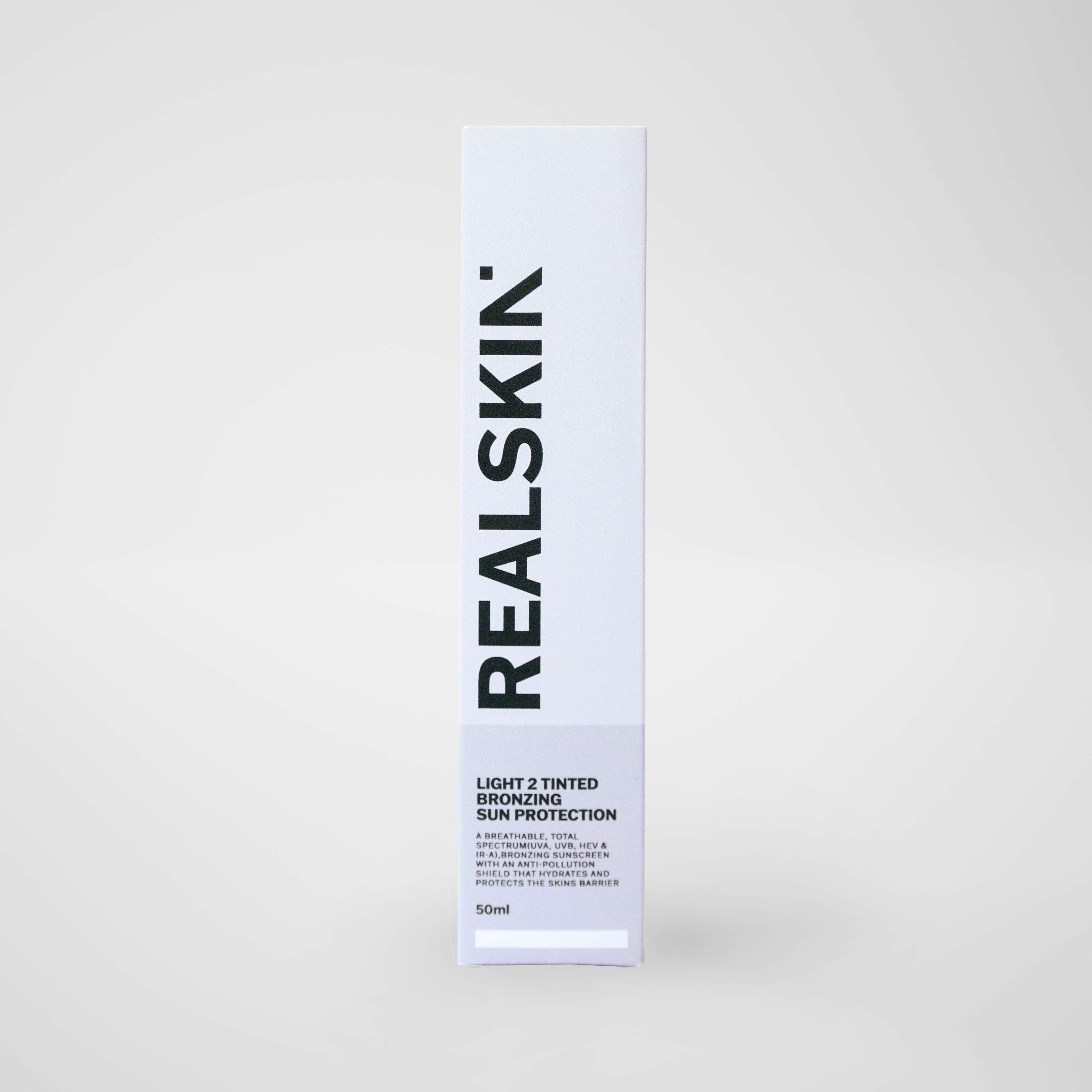 Realskin Sun Protection Light 2 Tinted Bronzing in a two-tone lighter grey rectangle box