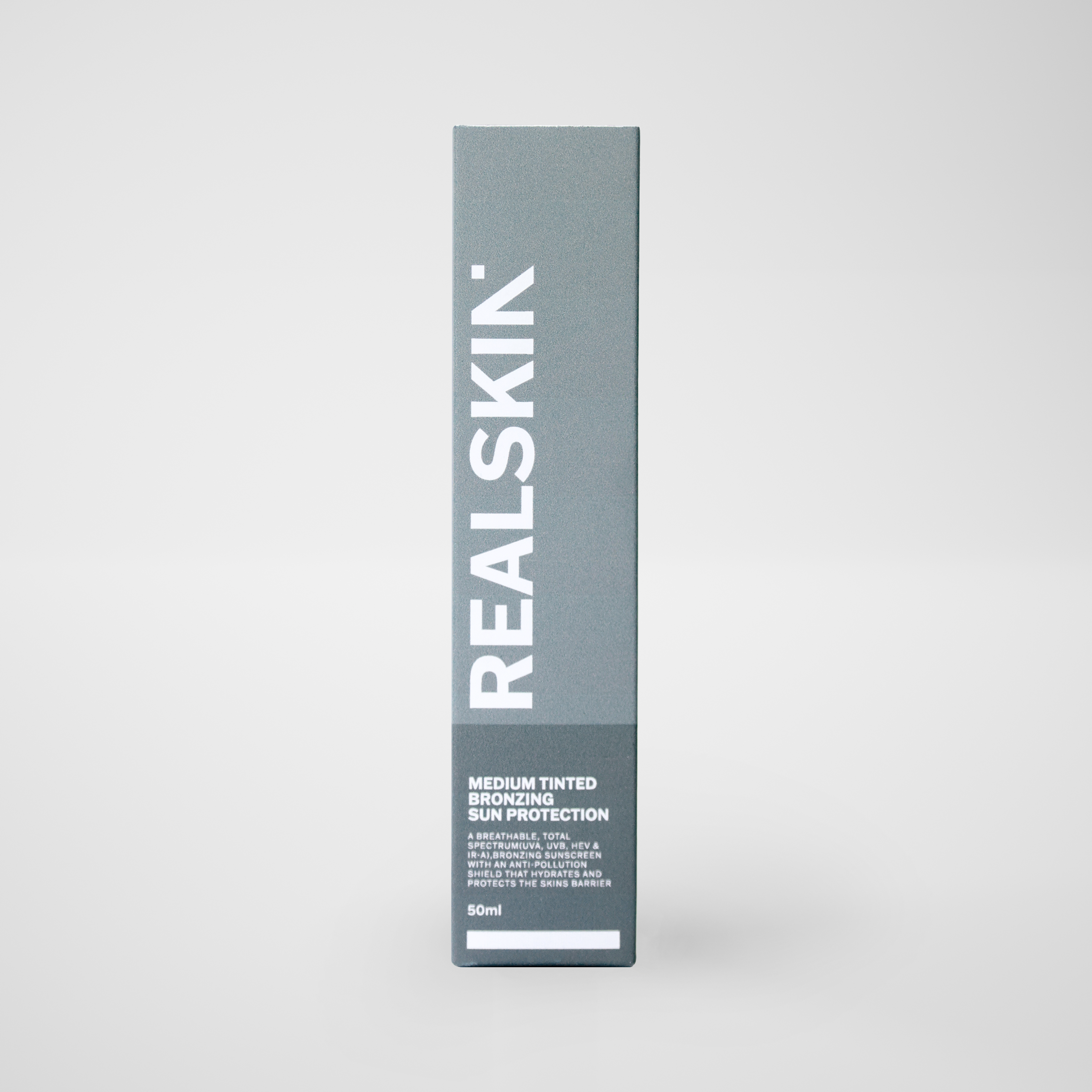 Realskin Sun Protection Medium Tinted Bronzing in a two-tone medium grey rectangle box
